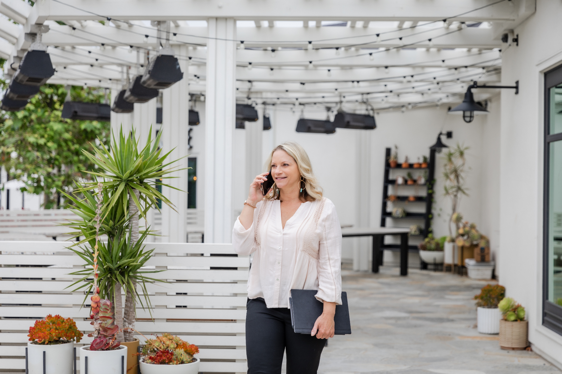 Reina Madriz on a call at an outdoor patio
